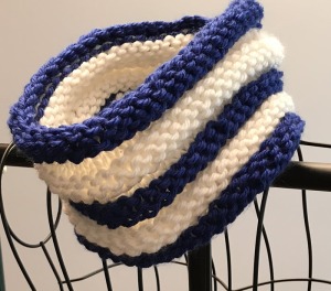 A blue and white striped knitted cowl